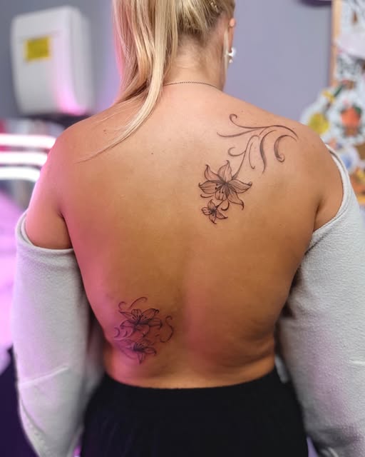 Fine-line floral tattoo from Sugar Tatts' portfolio
